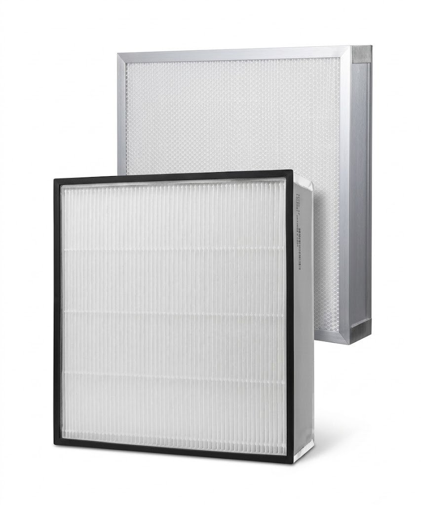 Engineer installing HEPA filter in cleanroom